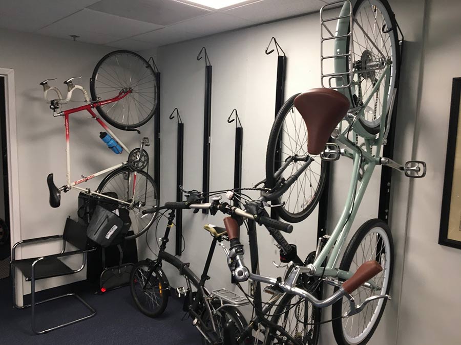 Bikes hanging on a vertical wall bike rack